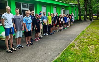 Ребята выстроились у корпуса летнего лагеря
